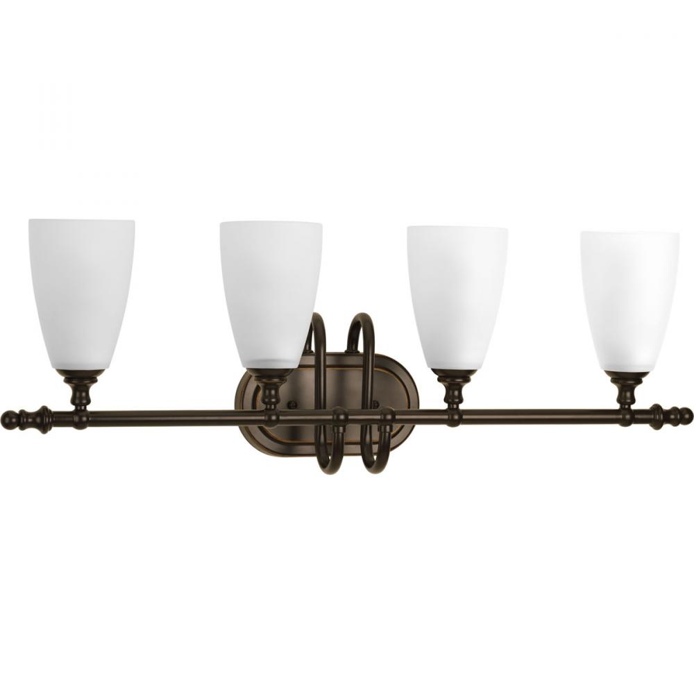 Four-light bath and vanity fixture finished in antique bronze with an etched glass shade. Part of th
